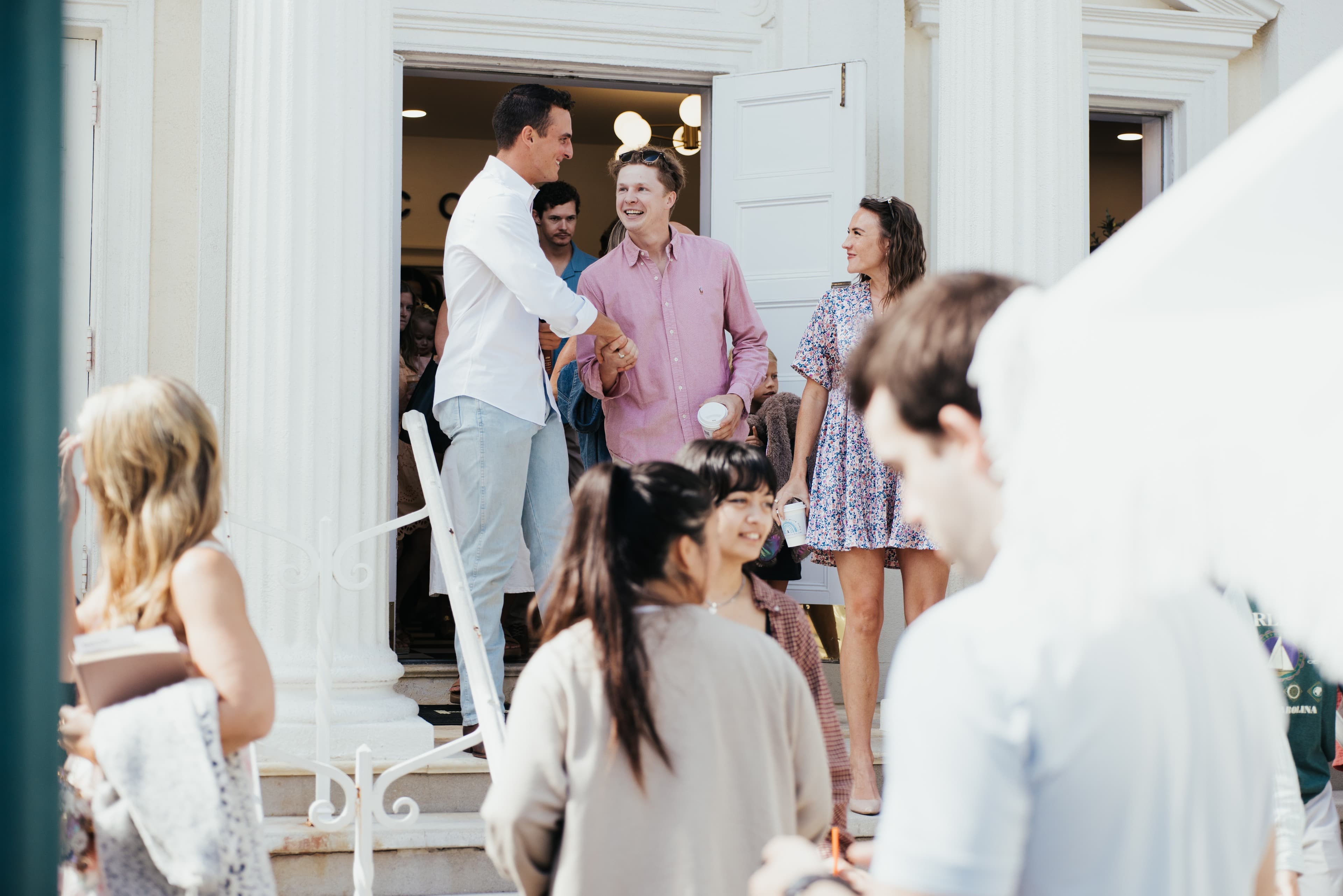 Friends welcoming one another at the Harbour Church entrance